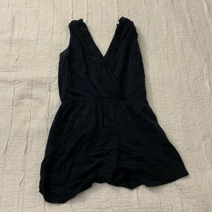 Dark blue romper with flower patterning. Wrap design on bust.